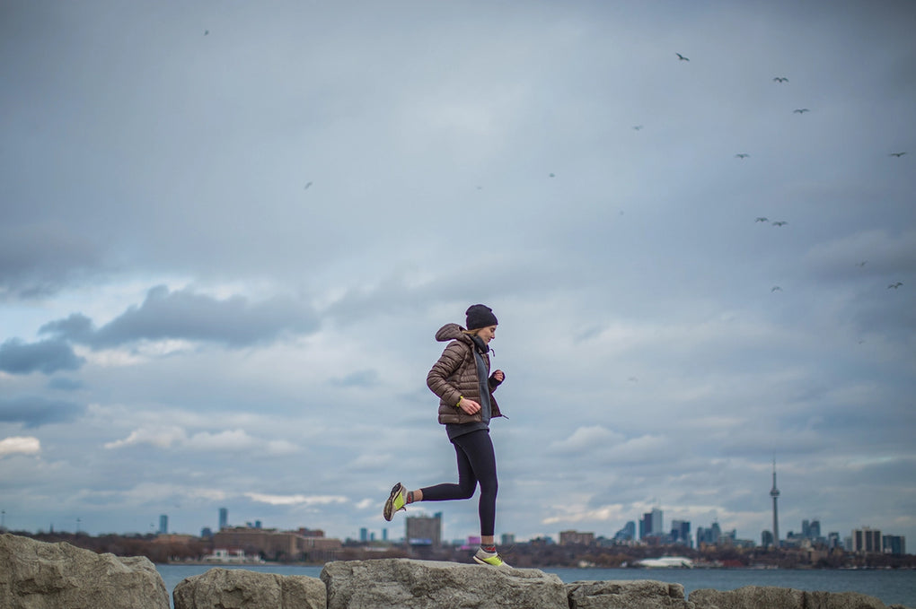 Lady running on a harbour wall