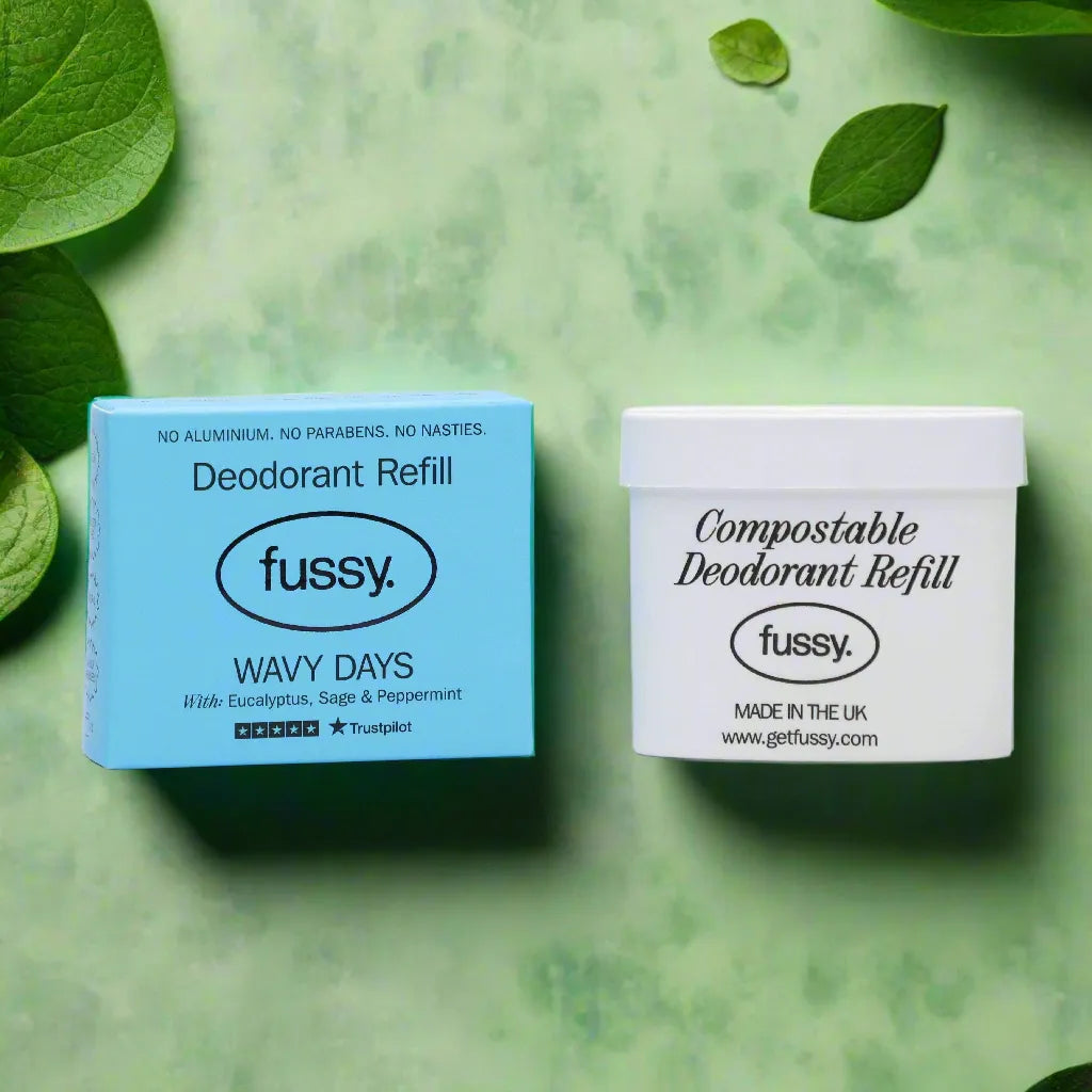 Fussy compostable deodorant refill and blue Wavy Days deodorant box on green background