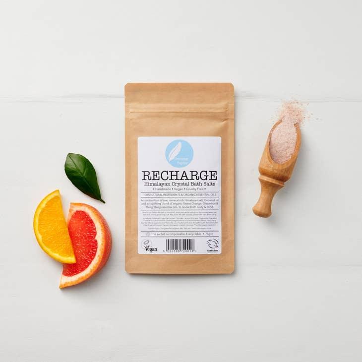 Recharge Himalayan crystal bath salts pouch with citrus slices, leaf, and bath salts on white background