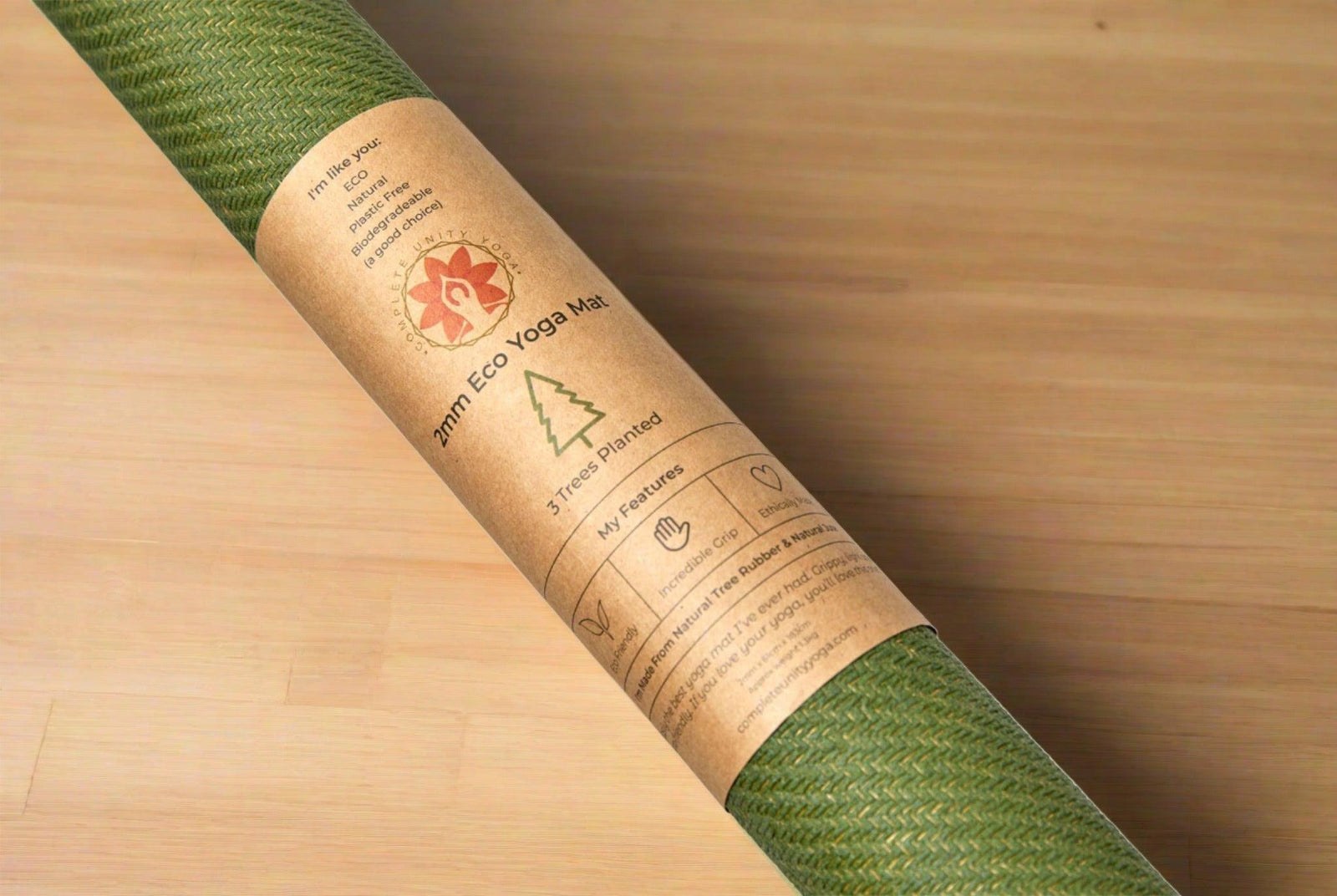 Green eco yoga mat with recycled paper label on wooden surface