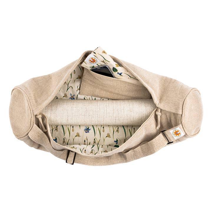 Beige yoga duffel bag with floral print lining and rolled mat inside