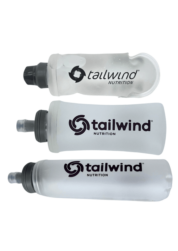 Three Tailwind Nutrition soft water bottles with black caps, arranged horizontally on white background