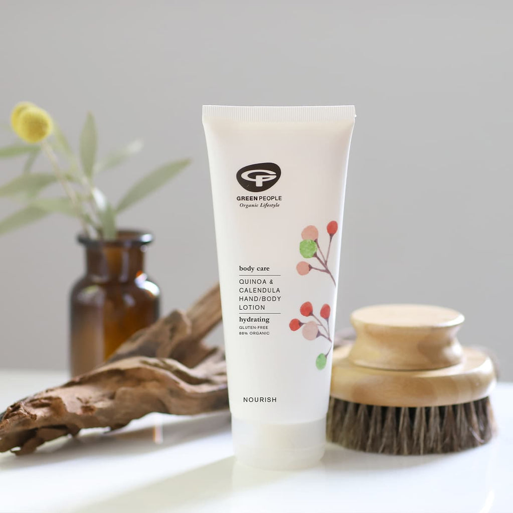 Green People Quinoa & Calendula hand body lotion tube with wooden brush and dried flowers