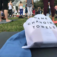 Game Changing Towels bag on yoga mat at outdoor yoga event