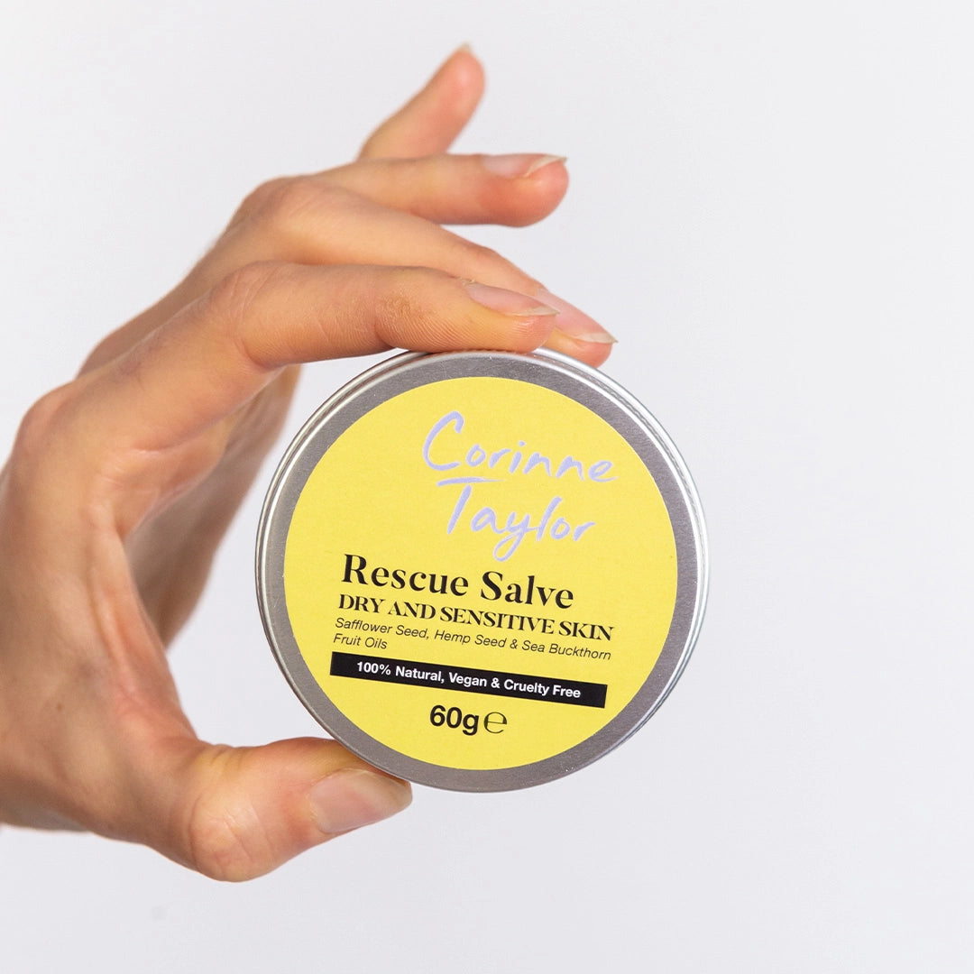 Hand holding Corinne Taylor Rescue Salve vegan body balm tin for dry sensitive skin
