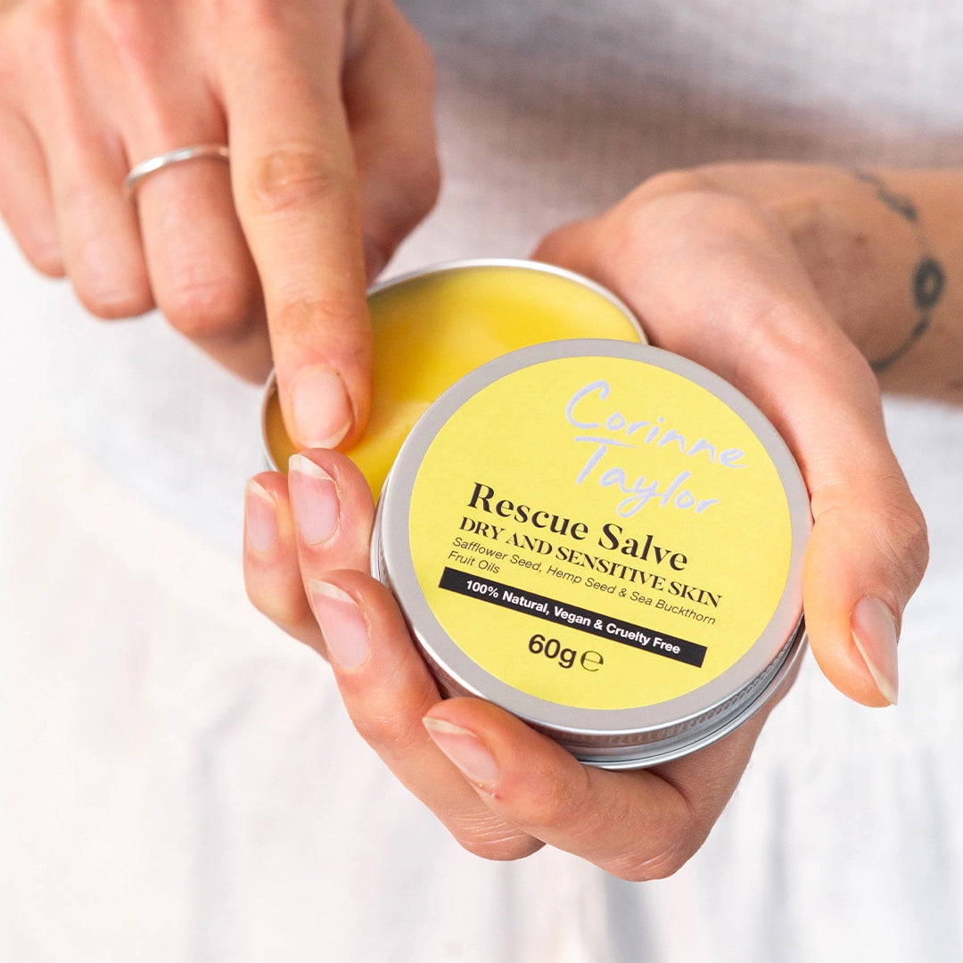 Hand holding Corinne Taylor Rescue Salve tin for dry and sensitive skin, natural skincare