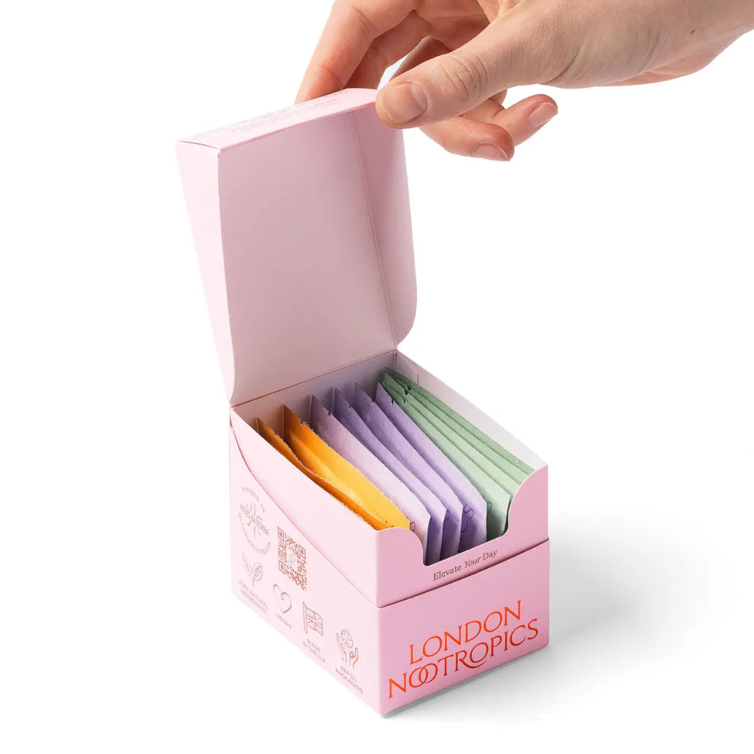London Nootropics selection box with assorted sachets and a hand opening the pink box