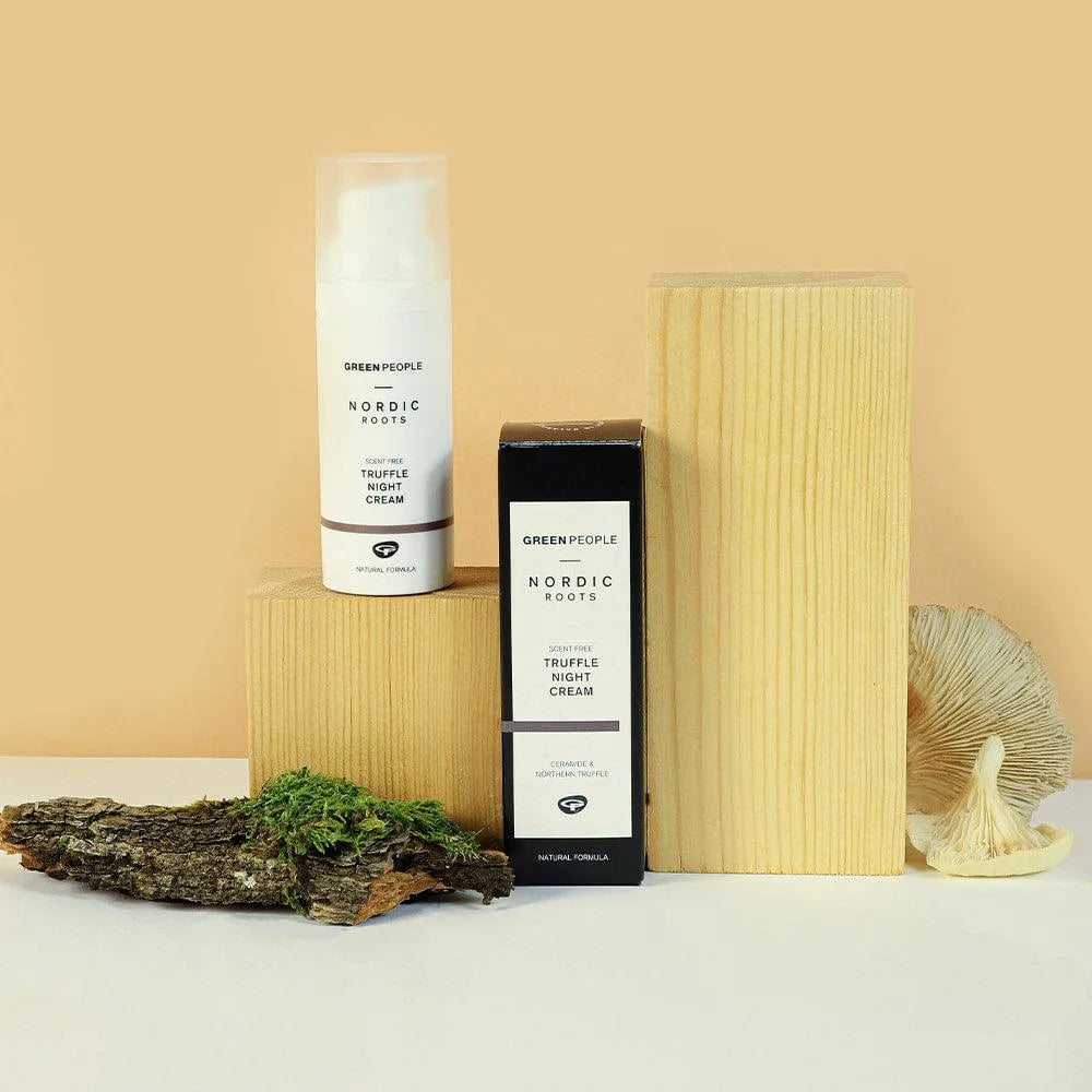 Green People Nordic Roots Truffle Night Cream on wood blocks with moss, bark, and mushroom