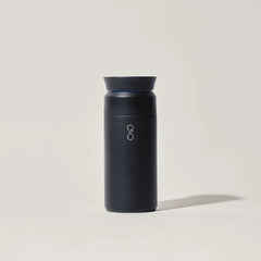 Obsidian black insulated travel coffee mug on plain light background