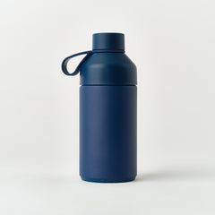 Matte ocean blue insulated water bottle with loop cap on plain white background