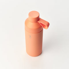 Sunset peach Ocean Bottle reusable water bottle with loop cap on white background