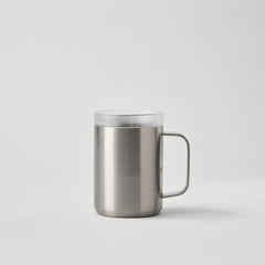 Stainless steel travel mug with handle and clear lid on plain background