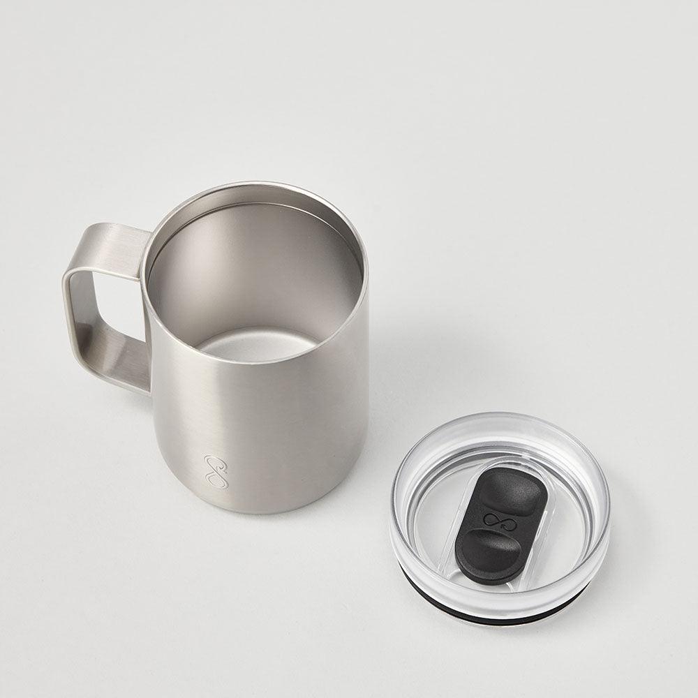 Stainless steel mug with clear lid and black slider on white background