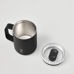 Black stainless steel mug with handle and clear lid on white background
