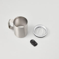 Stainless steel travel mug with handle, clear lid, and black slider on white background