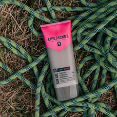 LifeJacket SPF 50+ Sun Gel tube on grass with green climbing rope outdoors