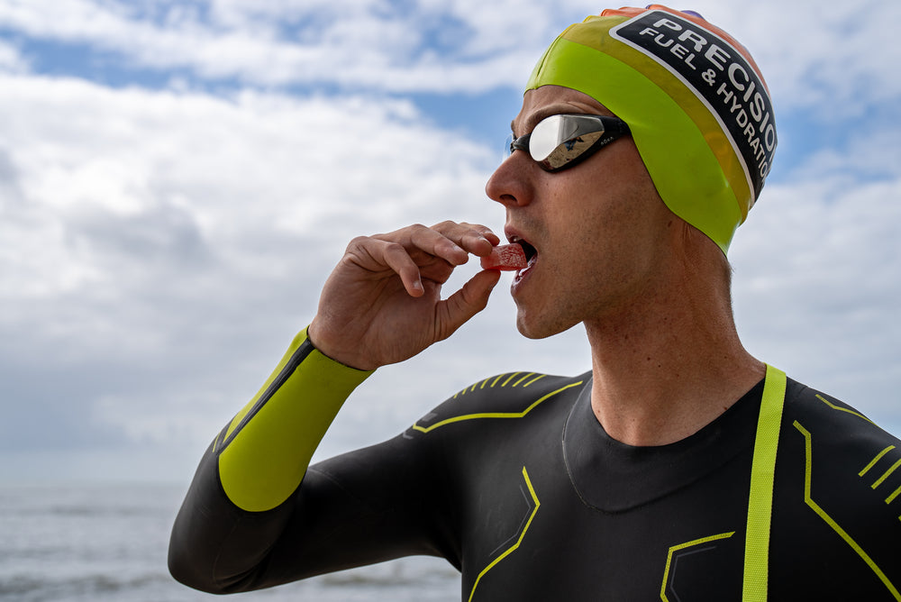 Triathlete eating an energy chew after swimming