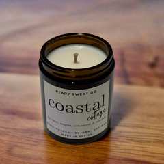 Coastal Cottage soy candle in amber jar on wooden surface, hand-poured, UK-made