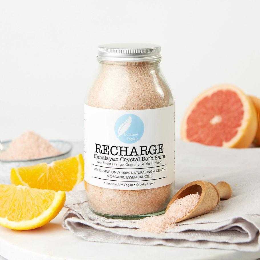 Recharge Himalayan crystal bath salts jar with orange and grapefruit slices