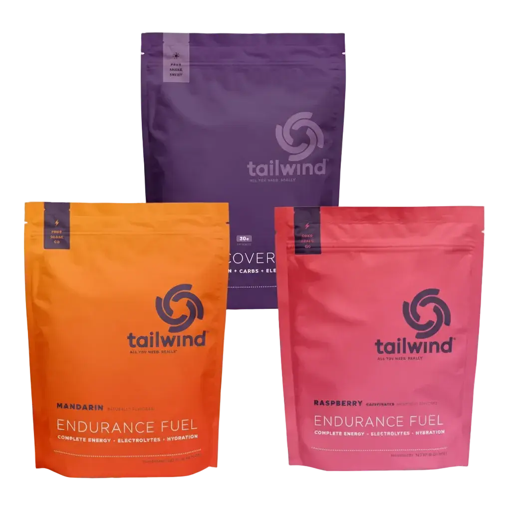 Tailwind Triple Bundle packages in purple, orange, and pink on a white background.