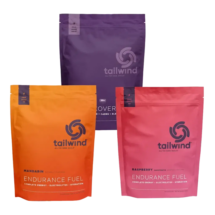 Tailwind Triple Bundle packages in purple, orange, and pink on a white background.