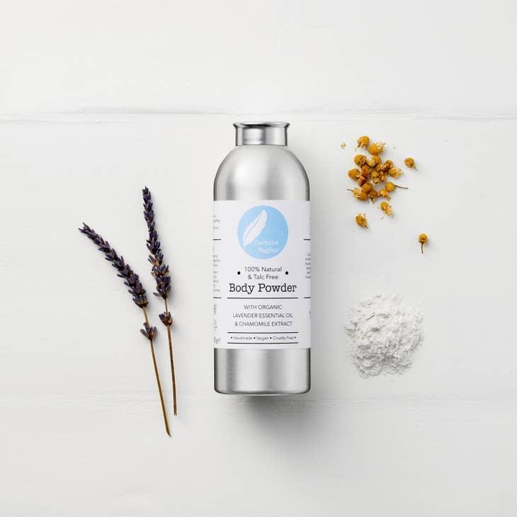 Natural body powder with lavender, chamomile flowers, and powder on white background