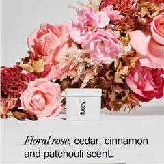 Fussy deodorant with pink roses, cinnamon sticks, and floral bouquet on white background.