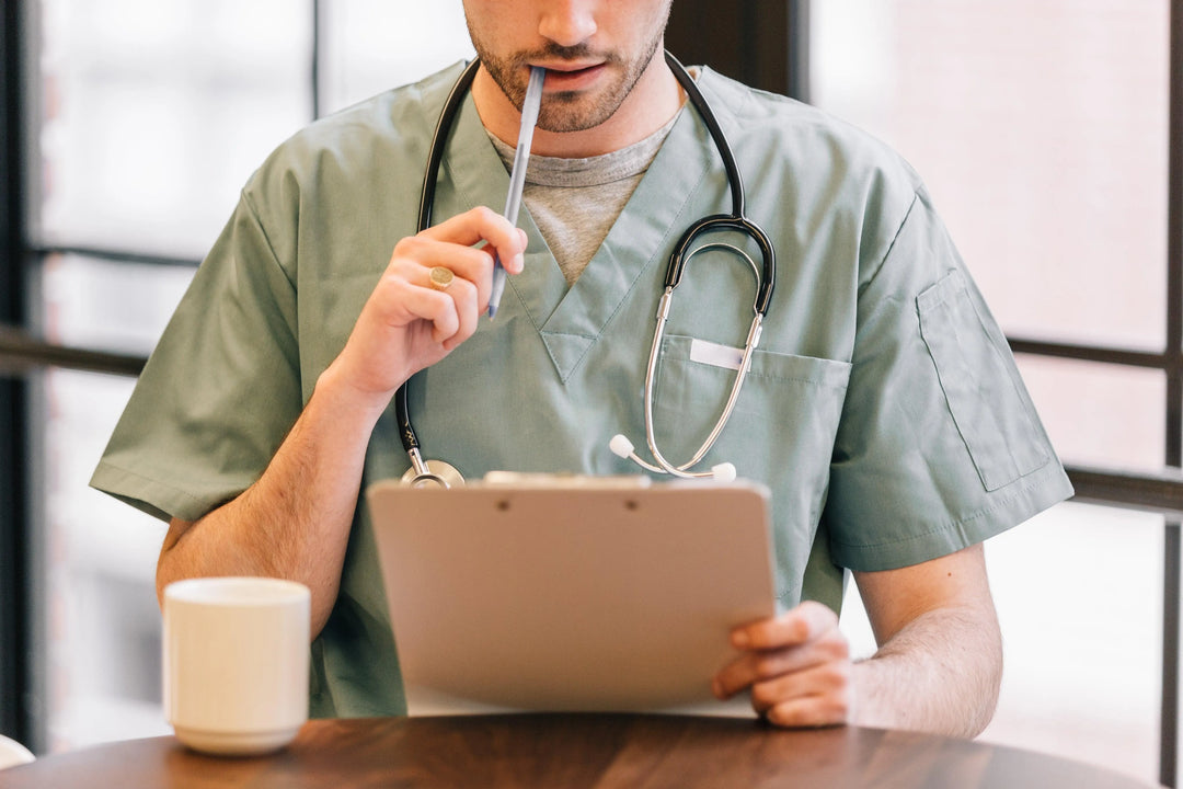 doctor-looking-at-clipboard - Ready Sweat Go