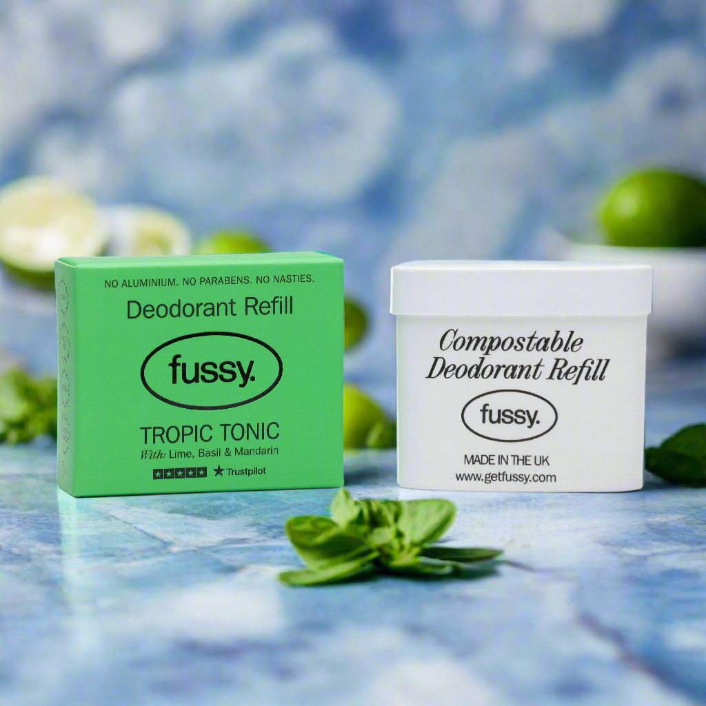 Fussy compostable deodorant refill and Tropic Tonic lime basil mandarin box on blue background