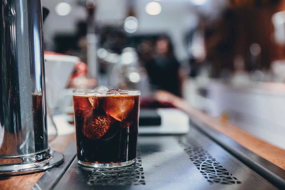 Glass of iced coffee on a cafe counter