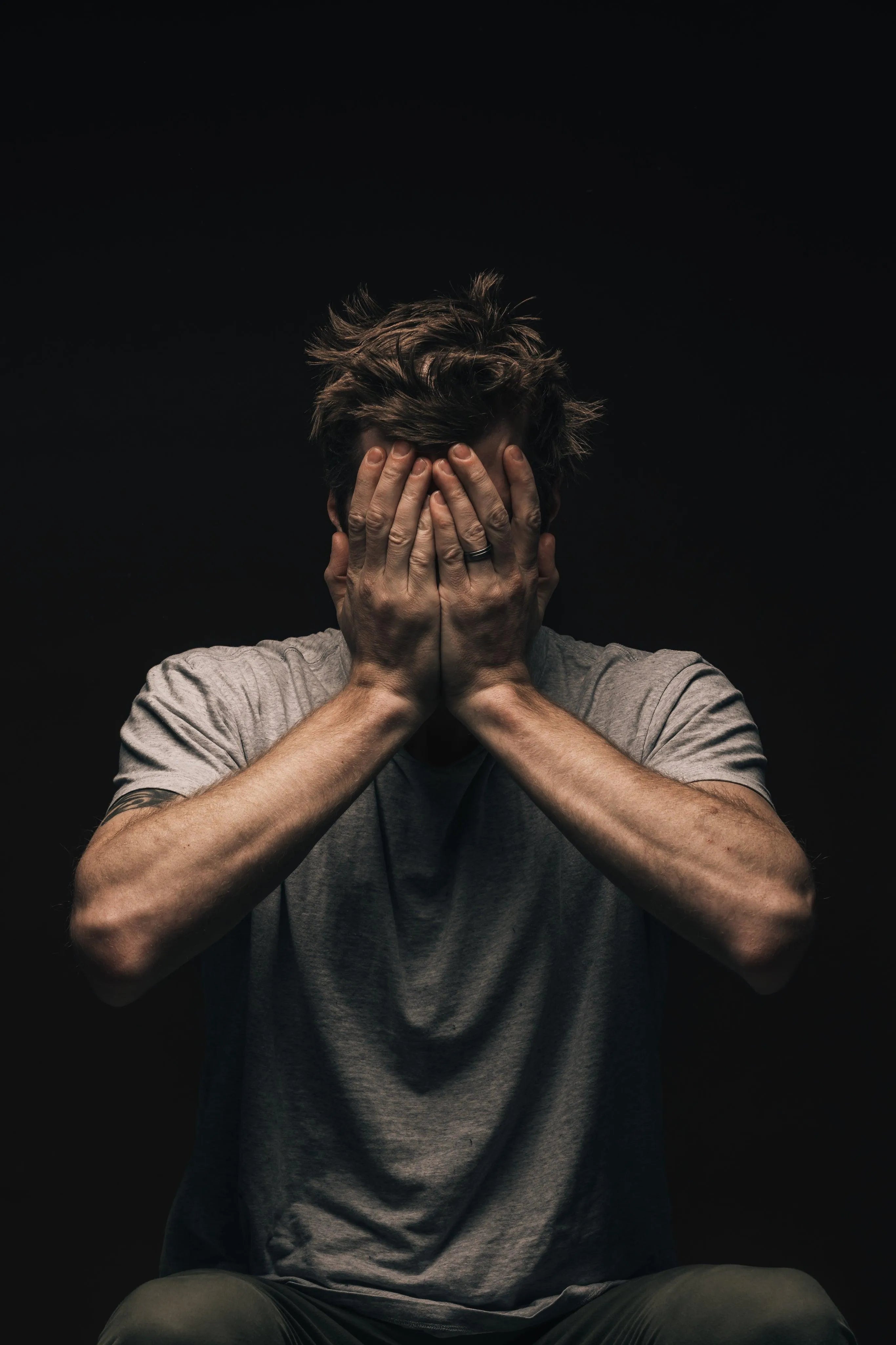 man-covering-face-with-hands - Ready Sweat Go