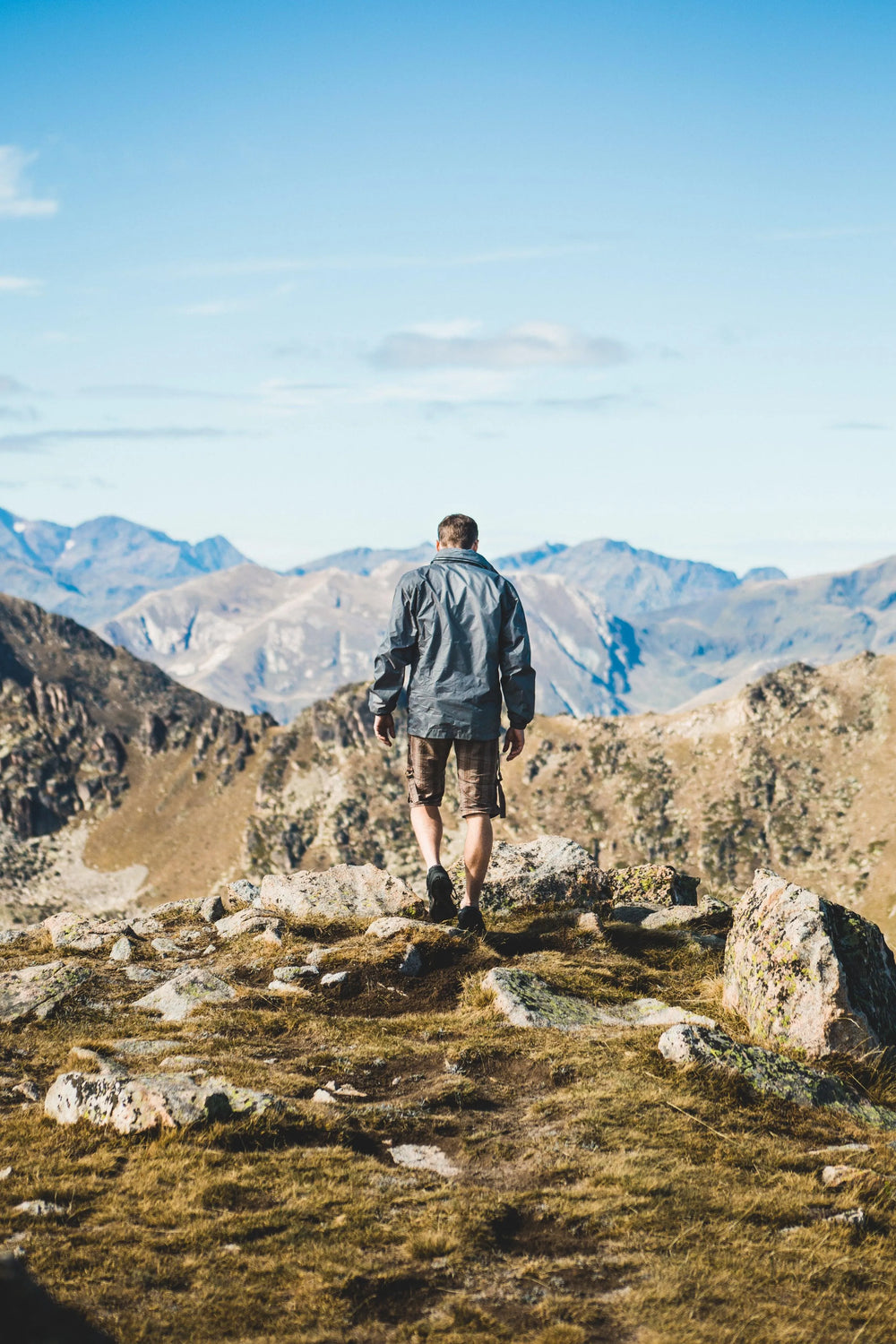 Hiker moving through mountain terrain