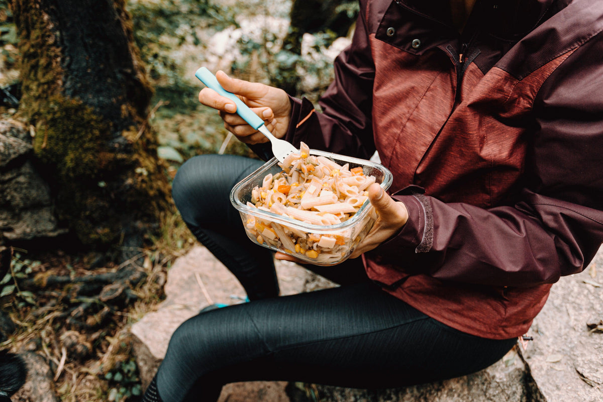 Endurance athlete eating a familiar meal outdoors before a long activity