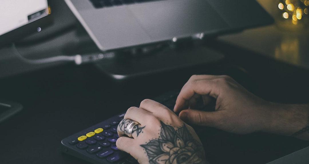tattooed-hands-typing-on-office-keyboard - Ready Sweat Go