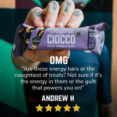 Hand holding Veloforte Ciocco energy bar with dates, almonds, cocoa and customer review.