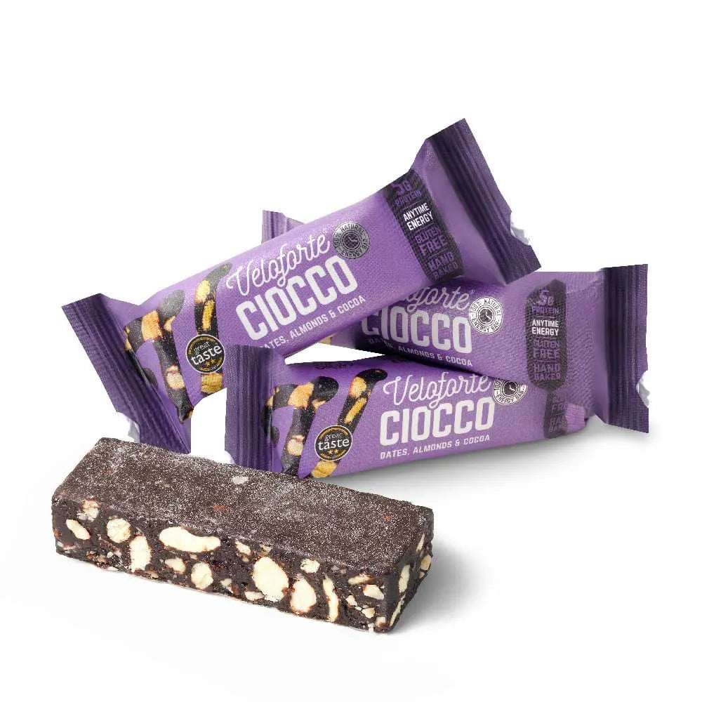 Veloforte Ciocco energy bars with almonds and cocoa, purple packaging, and one unwrapped bar.
