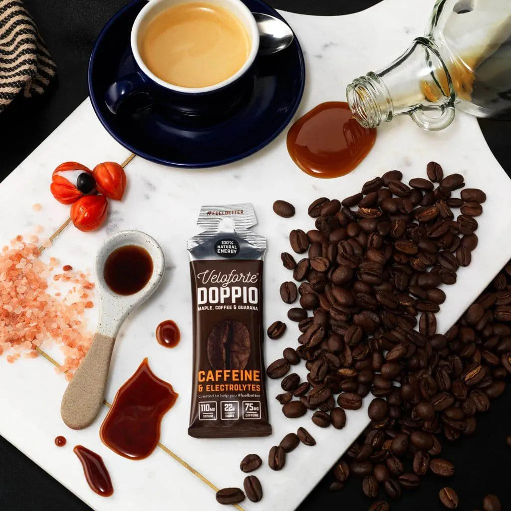Veloforte Doppio caffeine energy gel with coffee beans, espresso, guarana, and salt on marble