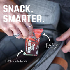 Hand holding Veloforte Orange &amp; Cacao snack bar over a bag, with text about whole foods.