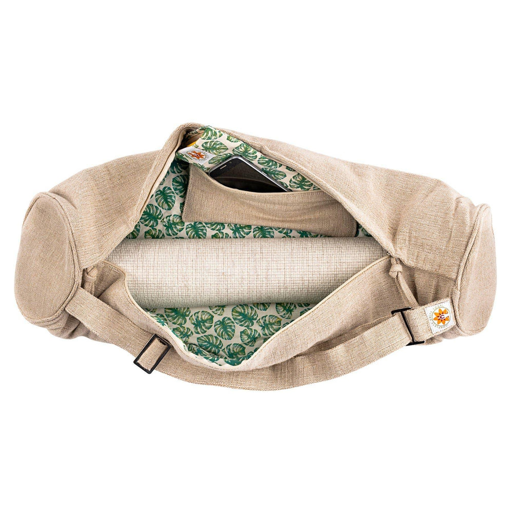 Open beige yoga mat bag with green leaf pattern lining and interior pocket